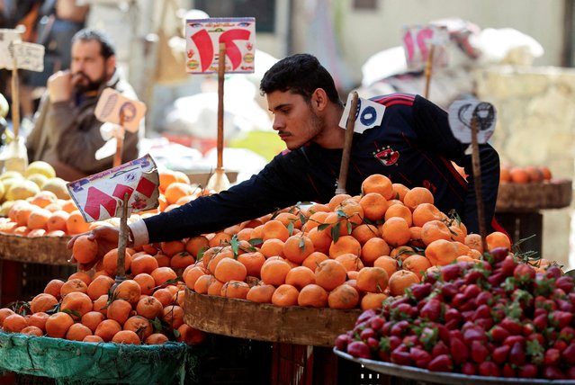 An Egyptian fruit seller works at a market in Cairo, Egypt, on March 7, 2024. (Photo by Mohamed Abd El Ghany/Reuters)