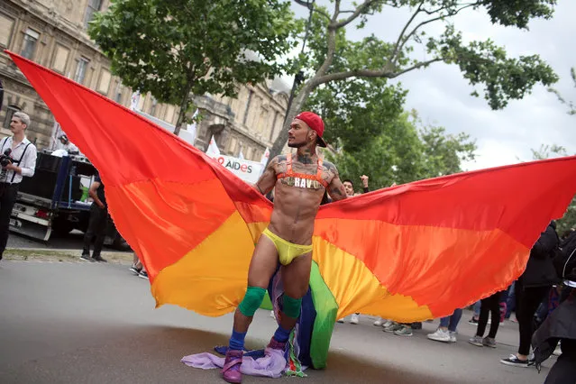 A reveler parades during the annual Gay Pride march in Paris, France, Saturday, July 2, 2016. Three weeks after the massacre at a Florida gay nightclub, people celebrate gay rights movement. (Photo by Thibault Camus/AP Photo)
