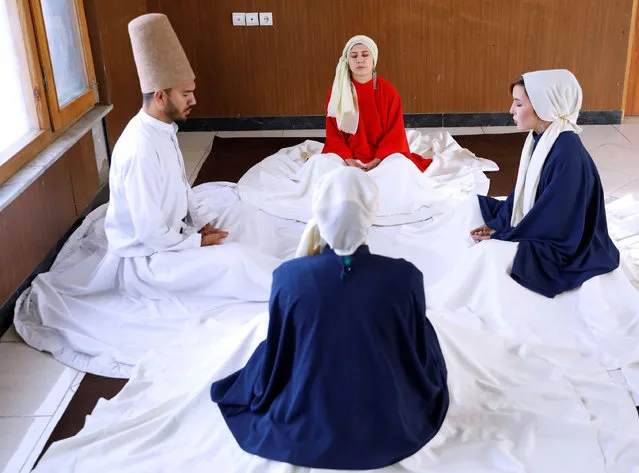 Fahima Mirzaie, 23, founder of a Sama Dance group meditates with her teammates before dancing in Kabul, Afghanistan on December 9, 2019. (Photo by Mohammad Ismail/Reuters)