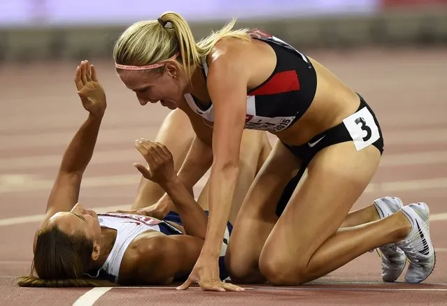 Jessica Ennis-Hill of Britain is congratulated by Brianne Theisen Eaton of Canada after winning the women's heptathlon during the 15th IAAF World Championships at the National Stadium in Beijing, China August 23, 2015. (Photo by Dylan Martinez/Reuters)