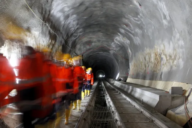 Visitors walk through the construction site of the NEAT Gotthard Base Tunnel at the Erstfeld-Amsteg section October 5, 2010. (Photo by Arnd Wiegmann/Reuters)