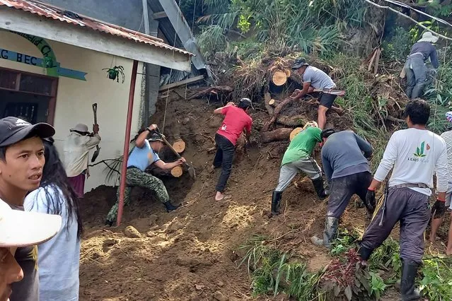 This handout photo released by the Police Regional Office-Cordillera (PROCOR) on July 27, 2022 shows villagers and rescue workers digging next to a chapel following a landslide caused by a 7.0-magnitude earthquake in the northern Philippines, in the village of Mayag in Bauko. (Photo by Police Regional Office-Cordillera (PROCOR)/Handout via AFP Photo)
