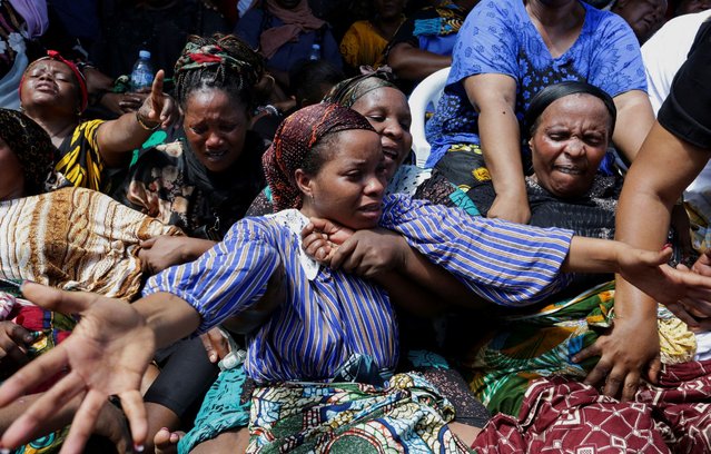 Relatives mourn at a farewell ceremony to remember the residents killed after a four-storey building collapsed over the weekend at the Kariakoo suburb, in Dar es Salaam, Tanzania on November 18, 2024. (Photo by Emmanuel Herman/Reuters)