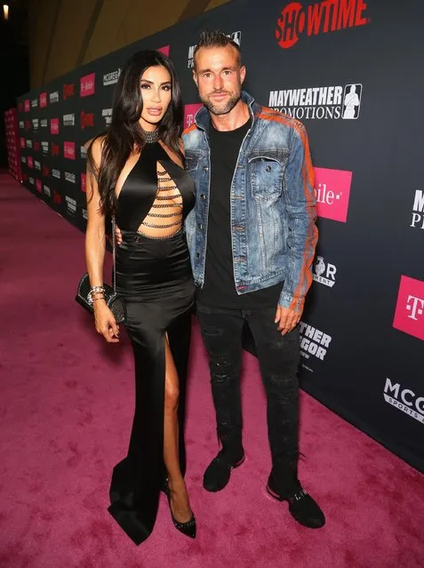 Morgan Osman (L) and fashion designer Philipp Plein arrive on T-Mobile's magenta carpet duirng the Showtime, WME IME and Mayweather Promotions VIP Pre-Fight Party for Mayweather vs. McGregor at T-Mobile Arena on August 26, 2017 in Las Vegas, Nevada. (Photo by Gabe Ginsberg/Getty Images for Showtime)