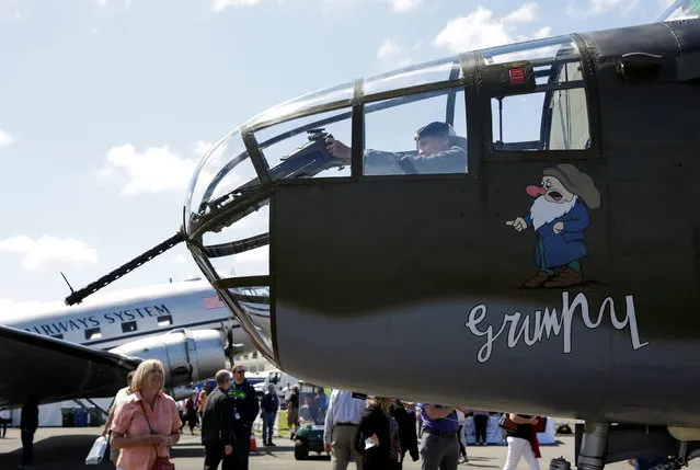 Nikita Ezhunov (R), 14, of Russia, sits inside a North American Aviation, B-25D Mitchell at an event marking the centennial of The Boeing Company in Seattle, Washington July 15, 2016. (Photo by Jason Redmond/Reuters)