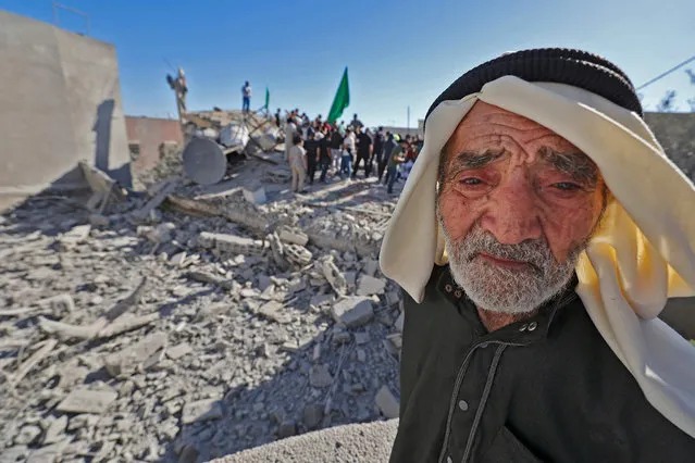 Grandfather of Palestinian militant Yehya Miri reacts after Israeli forces demolished their home in the village of Qarawat Bani Hassan in the Israeli-occupied West Bank July 26, 2022. Israeli forces demolished the homes of two Palestinians in the occupied West Bank accused of shooting dead a Jewish settler in April, an army statement said. (Photo by Jaafar Ashtiyeh/AFP Photo)