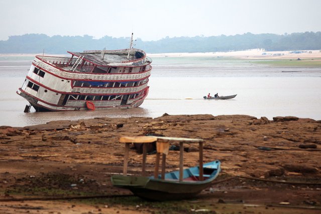 Boats are seen stranded at David's Marina, as the water level at a major river port in Brazil's Amazon rainforest hit its lowest point in at least 121 years on Monday, at the Rio Negro river in Manaus, Brazil on October 16, 2023. (Photo by Bruno Kelly/Reuters)