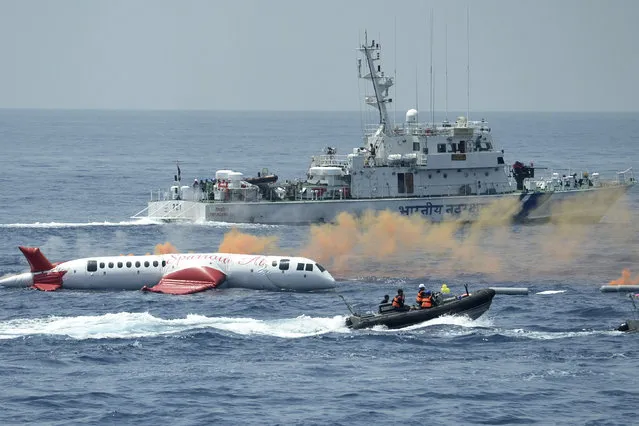 Indian Coast Guard cadets demonstrate during the National Maritime Search and Rescue Workshop and Exercise (SAREX-22) off the coast of Chennai on August 28, 2022. Eighteen ships and seven planes from the coast guard took part to demonstrate different techniques and technology exercise simulated to rescue from a passenger ship supposedly on fire and an aircraft that crashed into the sea. (Photo by Arun Sankar/AFP Photo)