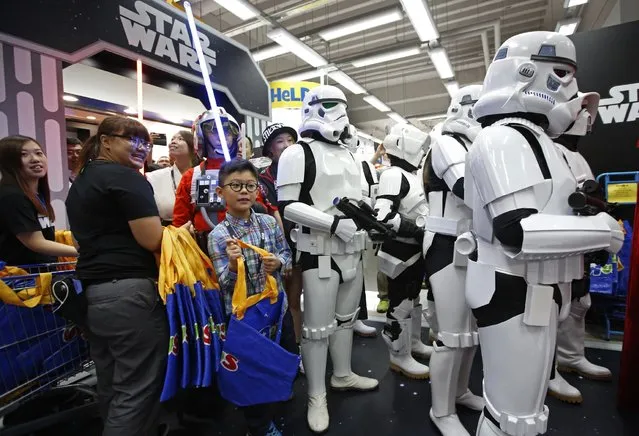 Star Wars fans shop at a toy store at midnight in Hong Kong, Friday, September 4, 2015 as part of the global event called “Force Friday” to release new Star Wars toys and other merchandise of the new movie “Star Wars: The Force Awakens”. (Photo by Kin Cheung/AP Photo)
