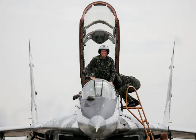 A pilot of a MIG-29 fighter aircraft smiles after landing at a military air base in Vasylkiv, Ukraine, August 3, 2016. (Photo by Gleb Garanich/Reuters)