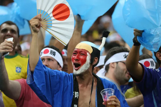 Fans of Japan's Olympic football team cheer for their team during a group B match of the men's Olympic football tournament between Japan and Nigeria at the Amazonia Arena, in Manaus, Brazil, Thursday, August 4, 2016. (Photo by Michael Dantas/AP Photo)