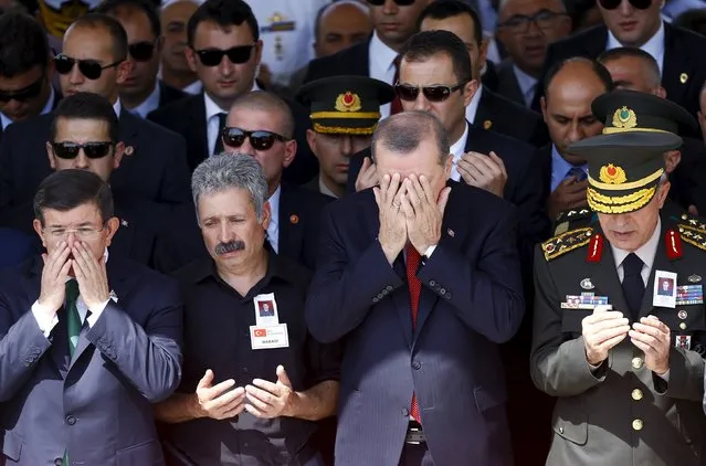 Turkish President Tayyip Erdogan (2nd R), Prime Minister Ahmet Davutoglu (L) and Chief of Staff General Hulusi Akar (R) pray during the funeral of Sergeant Okan Tasan, one of the soldiers killed during an attack on a military convoy and clashes on Sunday in the mountainous Daglica area of Hakkari province, at Kocatepe Mosque in Ankara, Turkey, September 10, 2015. (Photo by Umit Bektas/Reuters)