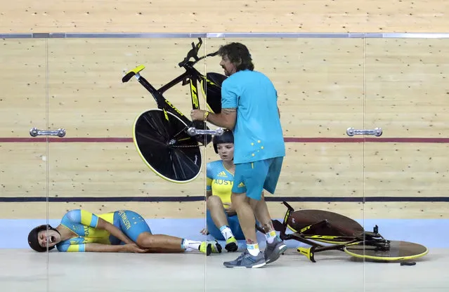 Melissa Hoskins, left, of the Australian women's track cycling team, reacts after crashing during a training session inside the Rio Olympic Velodrome during the 2016 Olympic Games in Rio de Janeiro, Brazil, Monday, August 8, 2016. (Photo by Patrick Semansky/AP Photo)