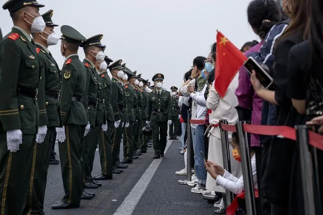 People's Liberation Army soldiers stand along a road at the end of the flag raising ceremony during National Day in Beijing, China, on Saturday, October 1, 2022. (Photo by Bloomberg)