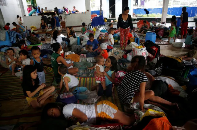 Flood victims take shelter at an evacuation centre after their homes were swamped by floods from monsoon rains in San Mateo, Rizal, Philippines, August 14, 2016. (Photo by Erik De Castro/Reuters)