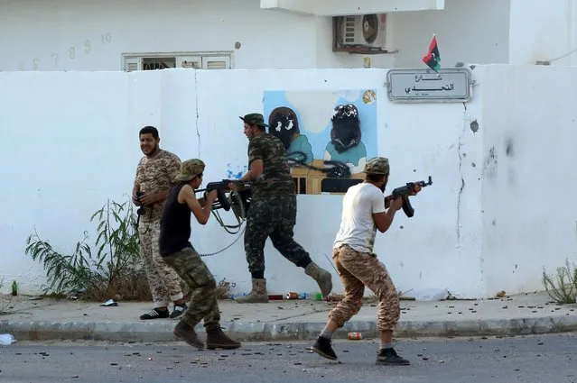 Forces loyal to Libya's UN-backed Government of National Accord (GNA) hold a position near the central area known as District One on August 21, 2016 as they fight against the Islamic State group (IS) jihadists holed up in the coastal city of Sirte, east of the capital Tripoli. Air force units of Libya's unity government launched an operation on August 20, 2016 to cut off potential escape routes for jihadists in Sirte, loyalist forces said. Pro-GNA forces, backed since early August by US air strikes, began an assault in mid-May to expel the Islamic State (IS) group from its Sirte stronghold. (Photo by Mahmud Turkia/AFP Photo)
