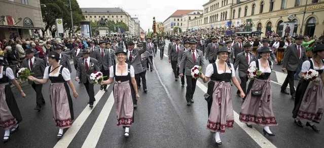People dressed in traditional Bavarian clothes take part in the Oktoberfest parade in Munich, Germany, September 20, 2015. (Photo by Lukas Barth/Reuters)