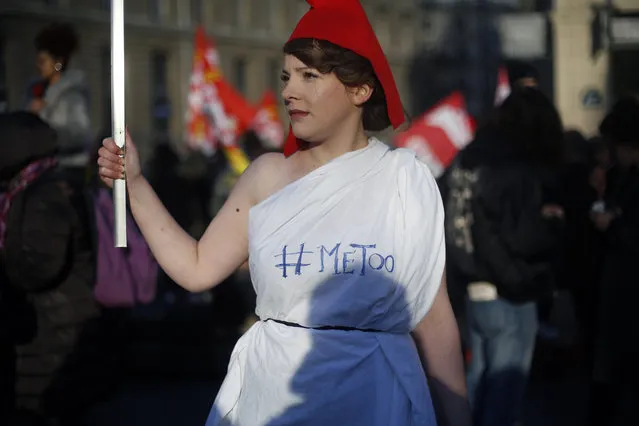A protestor wears a phrygian cap during a demonstration for the International Day for the Elimination of Violence against Women, in Paris, Saturday, November 25, 2017. (Photo by Thibault Camus/AP Photo)