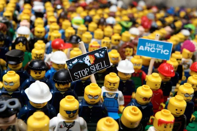 Undated handout photo issued by Greenpeace of Lego figures fitted with protest banners, by Greenpeace activtists, to save the Arctic from oil drilling, as Lego will not renew its promotional contract with Shell, the toy company has said after it was targeted by environmental campaigners who oppose the oil giant's plans to drill in the Arctic. (Photo by Jiri Rezac/Greenpeace/PA Wire)