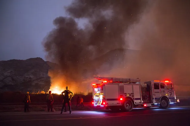 Santa Barbara firefighters try to keep the  Thomas Fire from jumping Highway 101 in Ventura County, California on December 7, 2017. Over 5,000 firefighters are battling four large wildfires in Southern California. Although strong winds are hampering efforts to contain these fires that have burned nearly 116,000 acres, firefighters have been successful in gaining some containment on these blazes. Extreme Santa Ana wind conditions are forecast today with sustained winds of 20 to 40mph and gusts potentially exceeding 80mph in some areas.  Teen and single digit daytime humidity persists, with very little overnight recovery. Windy and dry conditions will continue in Southern California into next week. Northern California remains dry, with temperatures expected to be above normal through the rest of the week.(Photo by Jim Seida/NBC News)