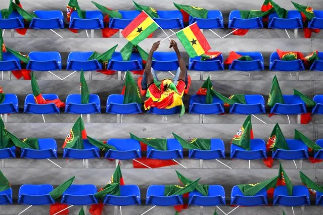 A  Ghana supporter waves flags in the tribunes prior to the  Qatar 2022 World Cup Group H football match between Portugal and Ghana at Stadium 974 in Doha on November 24, 2022. (Photo by Kirill Kudryavtsev/AFP Photo)