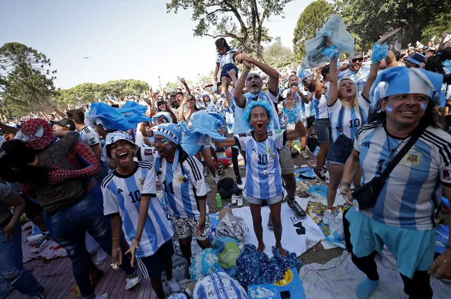 Argentina fans in Buenos Aires celebrate after Argentina's Lionel Messi scores the first goal in a World Cup semifinal match against Argentina in Qatar on December 13, 2022. (Photo by Agustin Marcarian/Reuters)