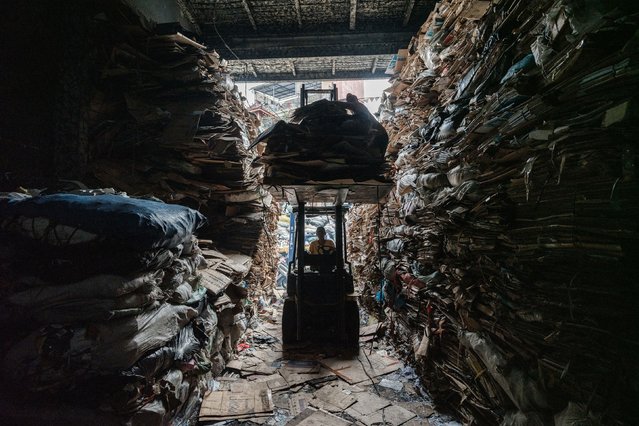 A forklift carries cardboard into a warehouse for recycling in Jakarta, Indonesia, on Sunday, May 4, 2025. (Photo by Yasuyoshi Chiba/AFP Photo)