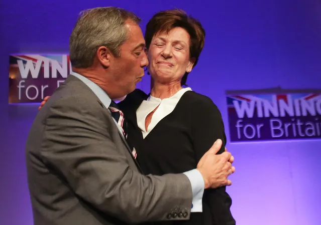 Outgoinng leader Nigel Farage (L) embraces new leader of the anti-EU UK Independence Party (UKIP) Diane James (R) as she is introduced at the UKIP Autumn Conference in Bournemouth, on the southern coast of England, on September 16, 2016. Diane James was announced as UKIP's new leader on September 16 to replace charismatic figurehead Nigel Farage. Farage made the shock decision to quit as leader of the UK Independence Party following victory in the referendum on Britain's membership of the European Union. (Photo by Daniel Leal-Olivas/AFP Photo)