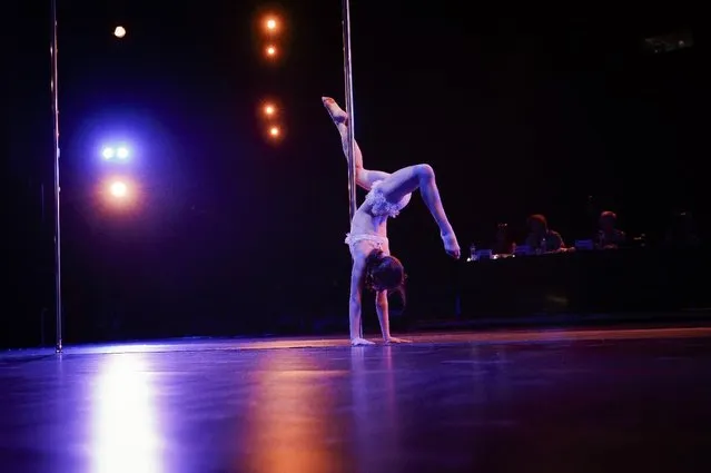 In this September 10, 2016 picture, a girl competes in the children category of the Romania Miss Pole Dance  Contest, ahead of the finals of the Pole Sport&Fitness World Championship  2016 in Bucharest, Romania. (Photo by Vadim Ghirda/AP Photo)