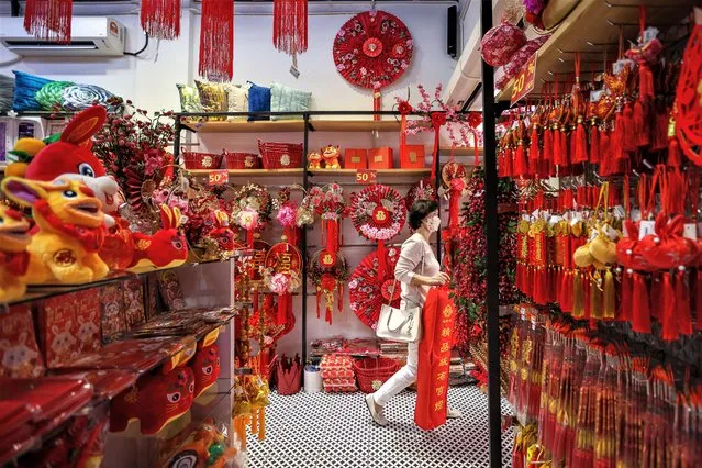 A woman shops for Lunar New Year decorations at Petaling Street, Chinatown on January 15, 2023 in Kuala Lumpur, Malaysia. (Photo by Annice Lyn/Getty Images)