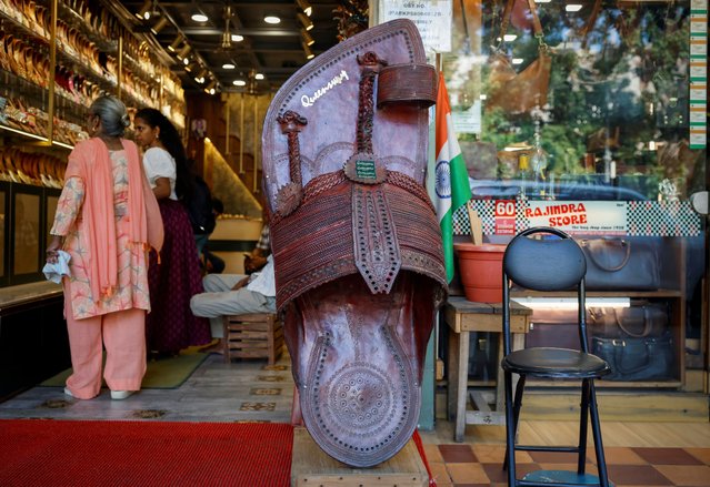 Customers shop for 'Kolhapuri' sandals, an Indian ethnic footwear, at a store in New Delhi, India, on June 27, 2025. (Photo by Adnan Abidi/Reuters)