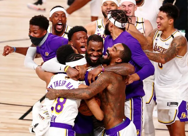 The Los Angeles Lakers celebrate after the Lakers defeated the Miami Heat 106-93 in Game 6 of basketball's NBA Finals Sunday, October 11, 2020, in Lake Buena Vista, Fla. (Photo by Kim Klement/USA TODAY Sports)