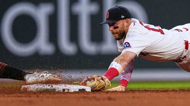 Boston Red Sox shortstop Trevor Story, right, dives to second while trying to pick off Baltimore Orioles' Colton Cowser during the third inning of a baseball game at Fenway Park, Tuesday, August 19, 2025, in Boston. (Photo by Charles Krupa/AP Photo)