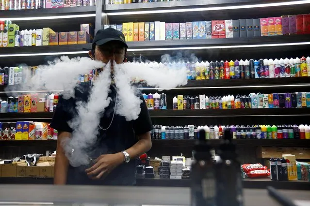 An employee vapes at a vape shop amid the coronavirus disease (COVID-19) outbreak in Jakarta, Indonesia, October 23, 2020. (Photo by Ajeng Dinar Ulfiana/Reuters)