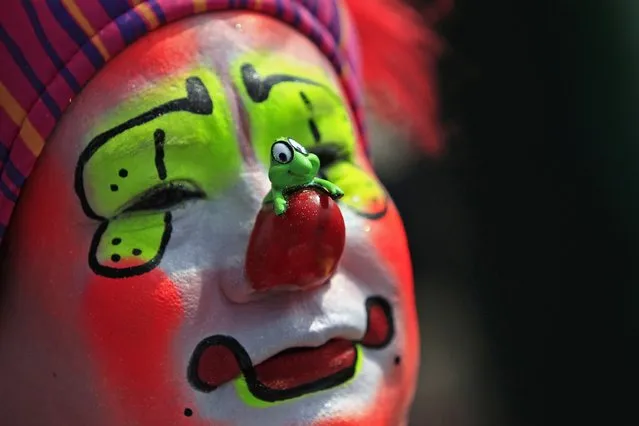 A clown looks on during the annual pilgrimage of clowns to the Basilica of Our Lady Guadalupe to pay homage to the Virgin of Guadalupe in Mexico City December 16, 2014. (Photo by Carlos Jasso/Reuters)