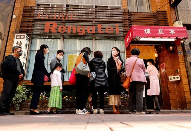 People form a line as they try to have lunch at Rengatei, a popular and long-established restaurant specialising in Japanese-style Western dishes, at Ginza district in Tokyo, Japan on March 16, 2023. (Photo by Issei Kato/Reuters)