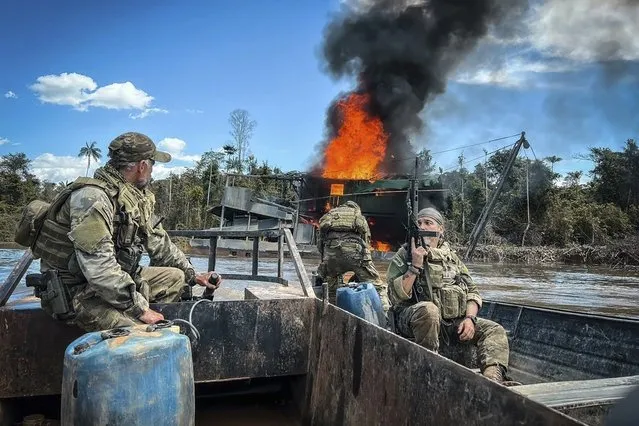 In this image provided by IBAMA, Brazil's Environmental Agency, federal agents destroy an illegal mining barge inside Yanomami Indigenous territory, Roraima state, Brazil, Tuesday, March 14, 2023. On Tuesday, federal agents seized multiple Starlink unit, an internet kit that provides high-speed connections even in remote places in Brazil's Amazon, like this mining pit. (Photo by IBAMA via AP Photo)