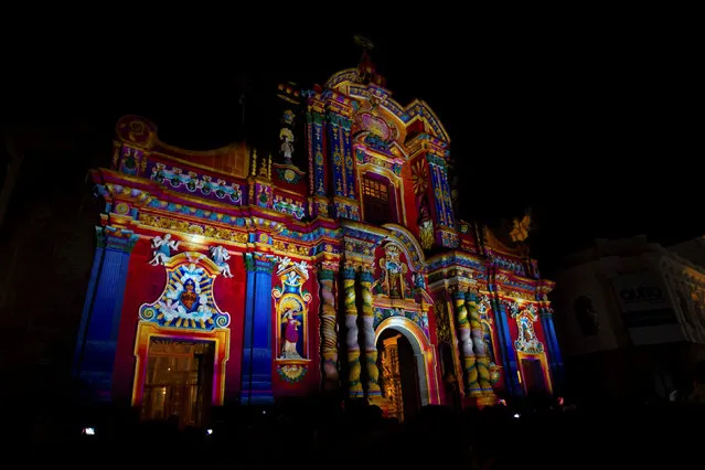 Thousands of pedestrians gather downtown for a lighting and chromalithe exhibition on a catholic church, as part of the UN Habitat III conference in Quito, Ecuador October 18, 2016. (Photo by Guillermo Granja/Reuters)