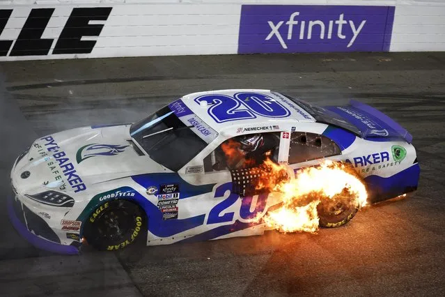 John Hunter Nemechek, driver of the #20 Pye Barker Fire & Safety Toyota, drives with a tire in flames after a burnout celebration after winning the NASCAR Xfinity SeriesCall811.com Before You Dig. 250 at Martinsville Speedway on April 15, 2023 in Martinsville, Virginia. (Photo by Jared C. Tilton/Getty Images)