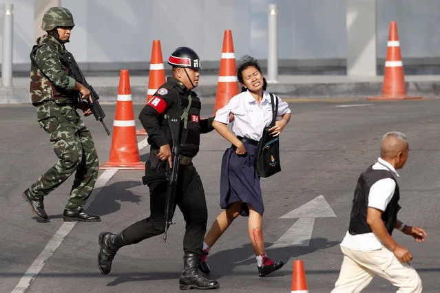 Soldiers evacuate a hostage from a mass shooting scene at the Terminal 21 shopping mall in Nakhon Ratchasima, Thailand, 09 February 2020. According to media reports, at least 21 people were killed, and as many as 30 wounded after a Thai soldier, identified as 32-year-old Jakraphanth Thomma, went on a shooting rampage with a M60 machine gun in the city of Nakhon Ratchasima, also known as Korat. Thomma held an unknown number of people hostage within the Terminal 21 shopping mall for around 17 hours before being shot and killed in a police operation. (Photo by Rungroj Yongrit/EPA/EFE)