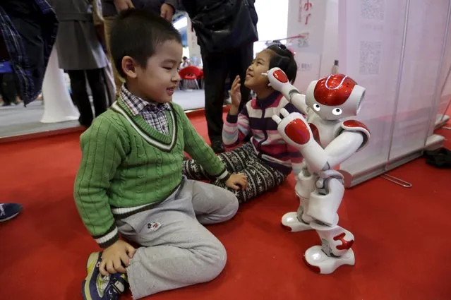 A "Nao" humanoid robot by Aldebaran Robotics dances to the Chinese song "Little Apple" at the World Robot Exhibition during the World Robot Conference in Beijing, China, November 24, 2015. The conference, which kicked off in Beijing on Monday, is a three-day event including a forum, an exhibition and a robot contest for youth, Xinhua News Agency reported. (Photo by Jason Lee/Reuters)