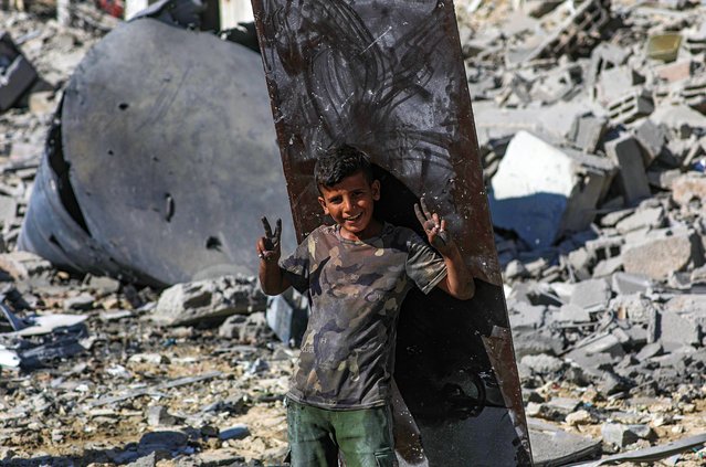 A Palestinian boy stands amid the rubble of destroyed buildings during a ceasefire between Israel and Hamas under the first phase of the Gaza peace plan, in Gaza City, Gaza Strip, 10 October 2025. Prime Minister Benjamin Netanyahu's office announced on 09 October that the Israeli government had approved the Gaza ceasefire and hostage release plan. (Photo by Mohammed Saber/EPA)