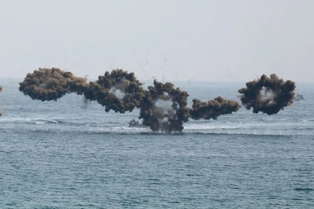 South Korean Marine's amphibious assault vehicles sail to shores in a smoke screen for landing during the combined military amphibious landing exercise between South Korea and the U.S, called Ssangyong exercise, in Pohang, South Korea, Wednesday, March 29, 2023. (Photo by Lee Jin-man/AP Photo)