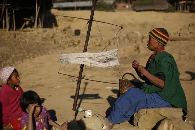 A Naga woman weaves using a traditional method in Yansi village, Donhe township in the Naga Self-Administered Zone in northwest Myanmar December 25, 2014. (Photo by Soe Zeya Tun/Reuters)