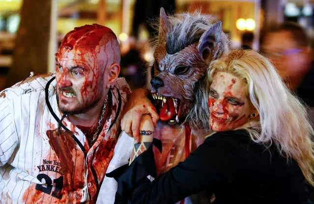 Revellers pose for pictures during the so-called “Zombie walk” through the western German city of Essen on Halloween Day, October 31, 2016. (Photo by Wolfgang Rattay/Reuters)