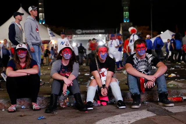 Fans of American League baseball team Cleveland Indians sit dejected after losing their Major League Baseball World Series game 7 to National League's Chicago Cubs outside Progressive Field in Cleveland, Ohio, U.S., November 3, 2016. (Photo by Shannon Stapleton/Reuters)