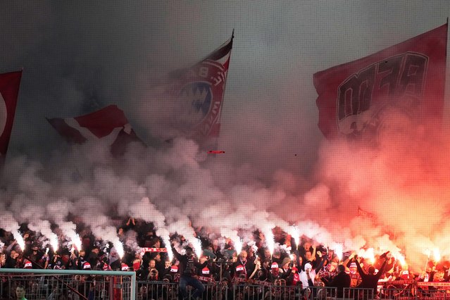 Fans light flares during the Champions League opening phase soccer match between FC Bayern Munich and Sporting CP in Munich, Germany, Tuesday, December 9, 2025. (Photo by Matthias Schrader/AP Photo)