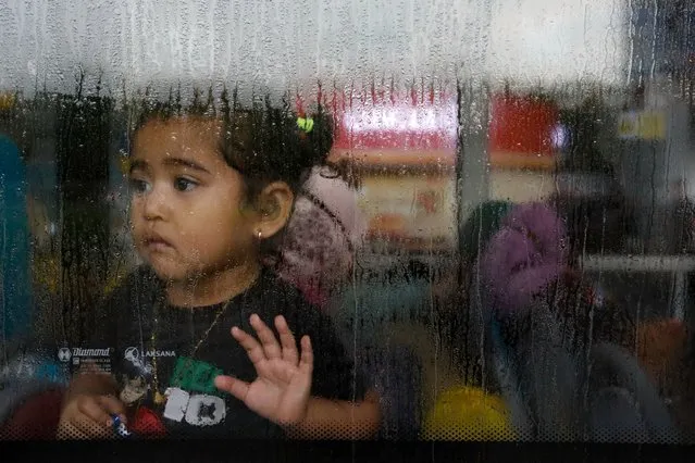 A girl evacuated from Sudan looks through the window of a bus after she arrives at the Soekarno-Hatta Airport in Tangerang, on the outskirts of Jakarta, Indonesia on April 28, 2023. (Photo by Ajeng Dinar Ulfiana/Reuters)