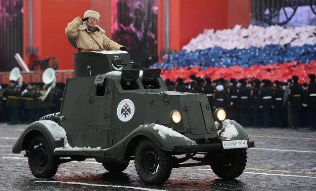 A participant rides an armored vehicle during the ceremonial march commemorating the 75th anniversary of the 1941 military parade on Red Square in Moscow, Russia on November 7, 2016. (Photo by Vladimir Astapkovich/Sputnik)