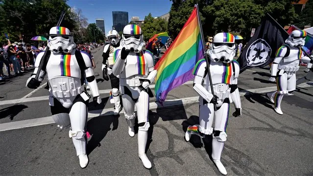 Participants wearing costumes take part in the Utah Pride Parade, Sunday, June 4, 2023, in Salt Lake City. (Photo by Rick Bowmer/AP Photo)